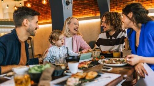 Family sitting around a restaurant bonding