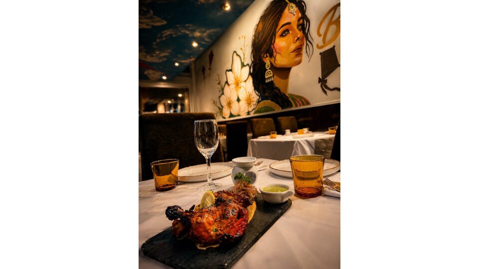 Indian chicken meal on a table with drinks