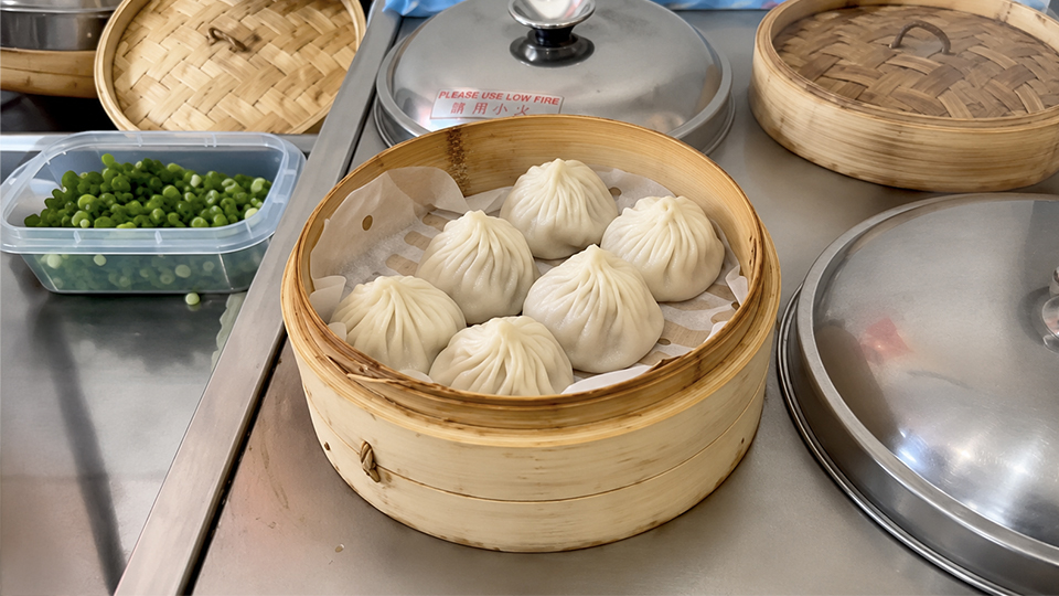 Image of 6 shanghai pork dumplings in a basket on the countertop from Bao Bao Go
